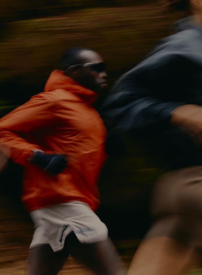 Runners on a track at sunset
